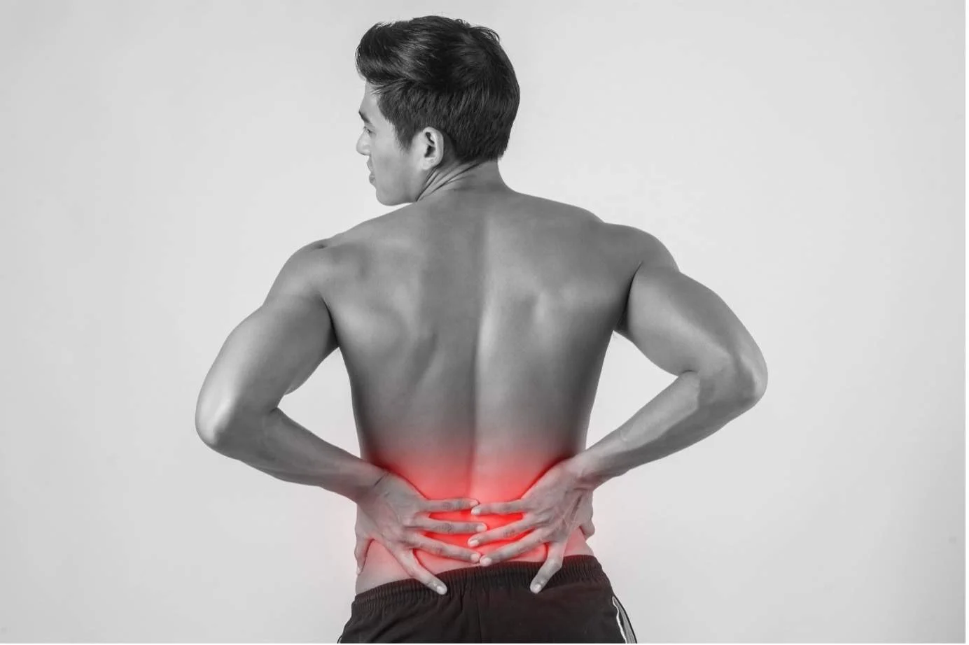Man holding his lower back due to lower back pain