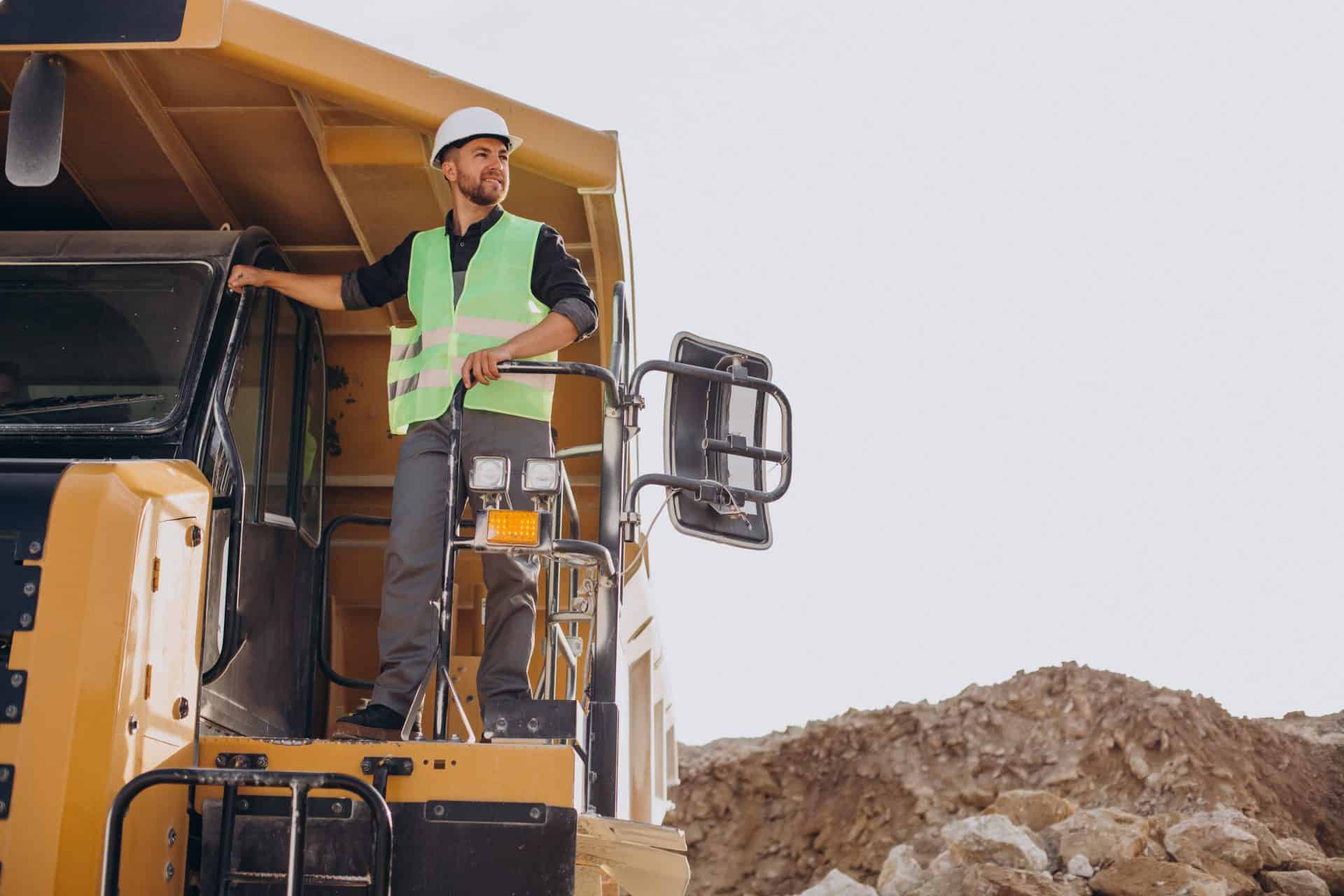 Male Worker With Bulldozer In Sand Quarry