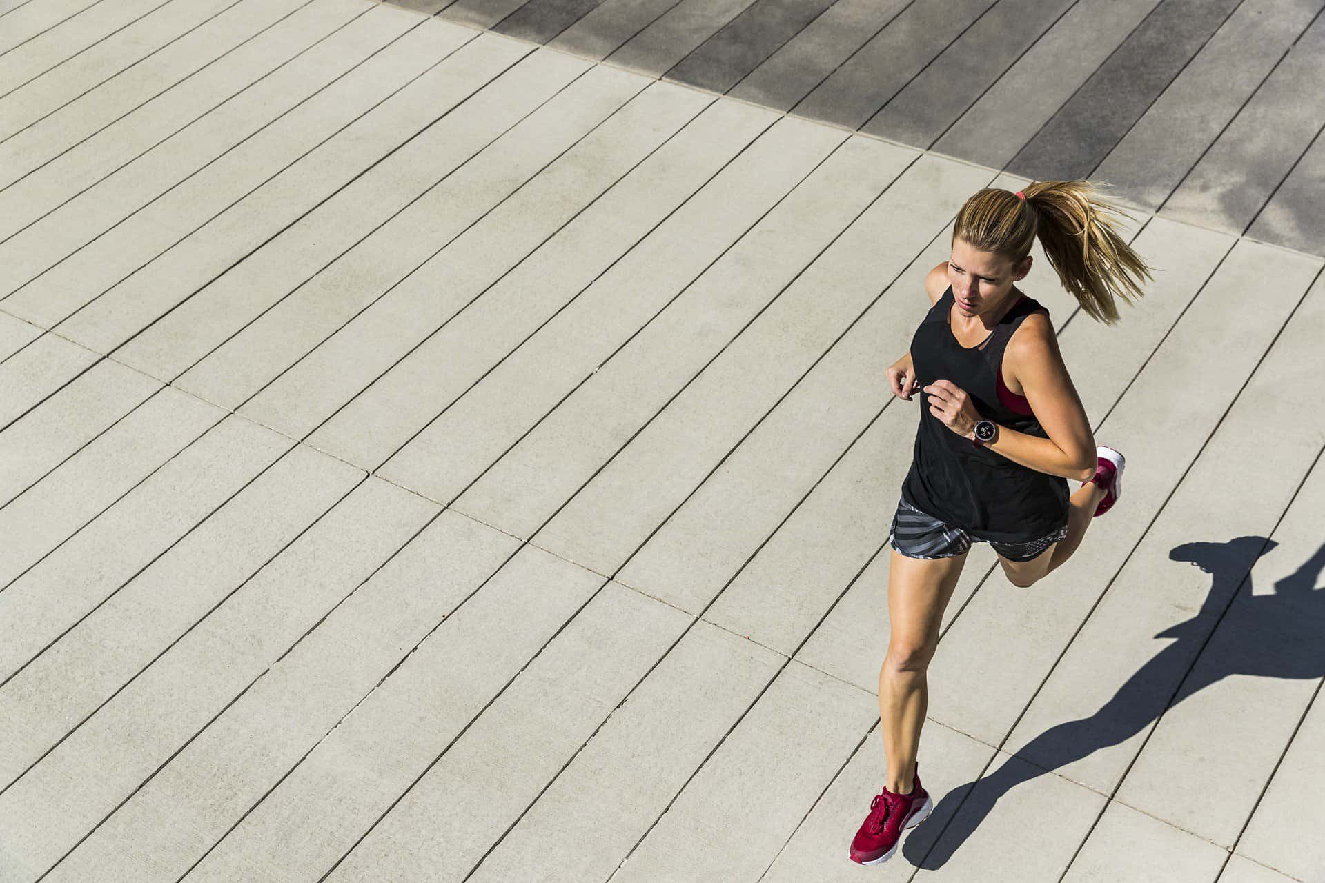 A healthy girl running on a boardwalk